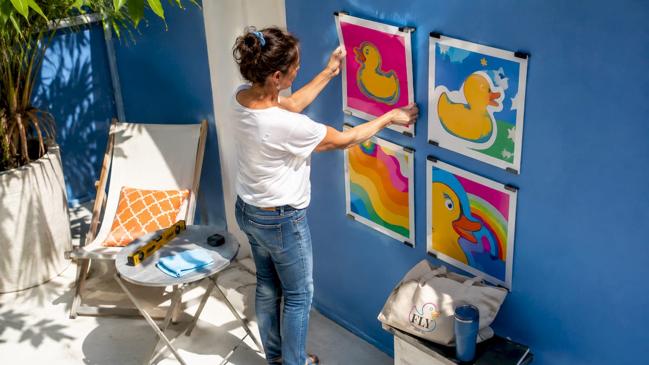 Woman rotating pop art print in home