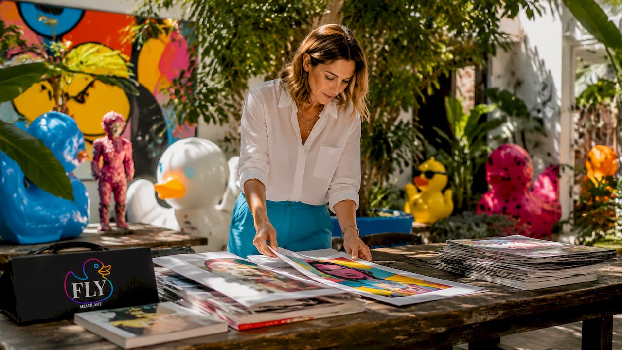 Art historian reviewing Pop Art prints in studio