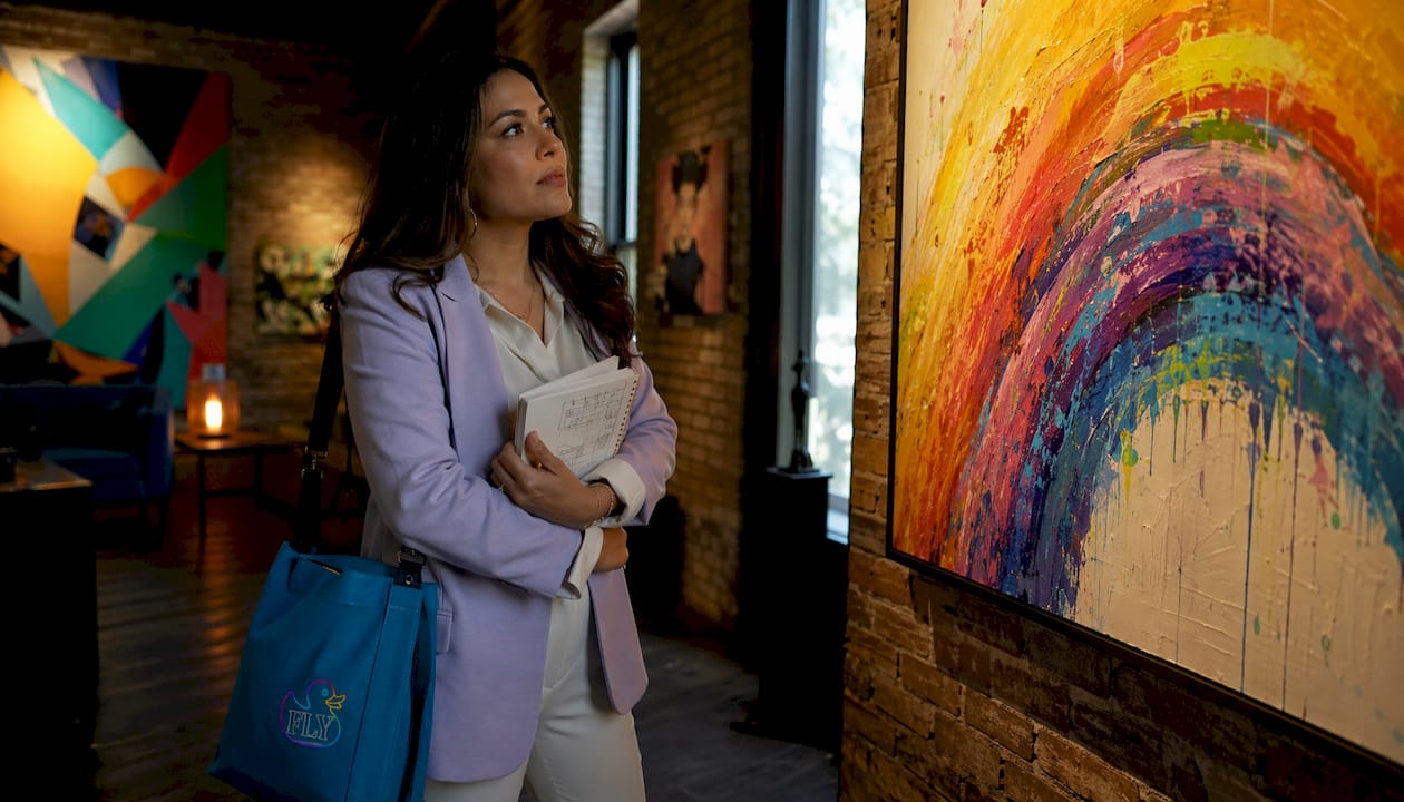 Woman examining historical rainbow painting