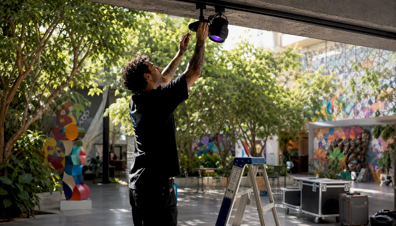 Technician adjusting blacklight in art gallery