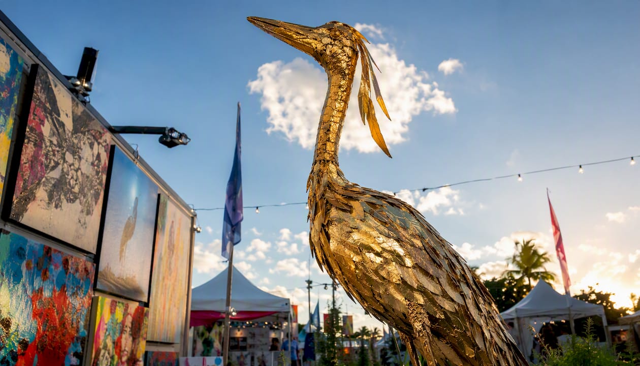Golden crane sculpture lit by studio light