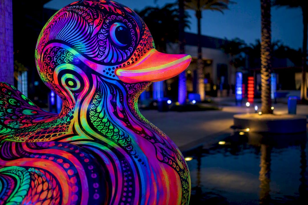 UV-reactive public art glowing at dusk