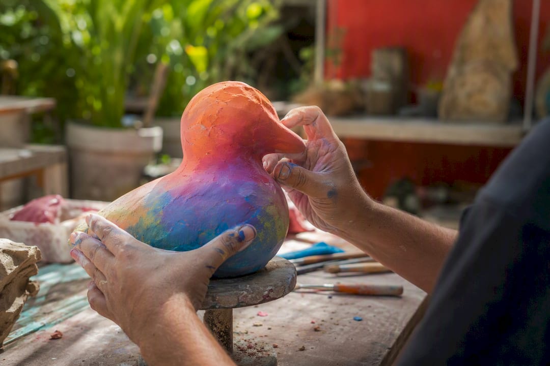 Hands shaping bespoke indoor sculpture