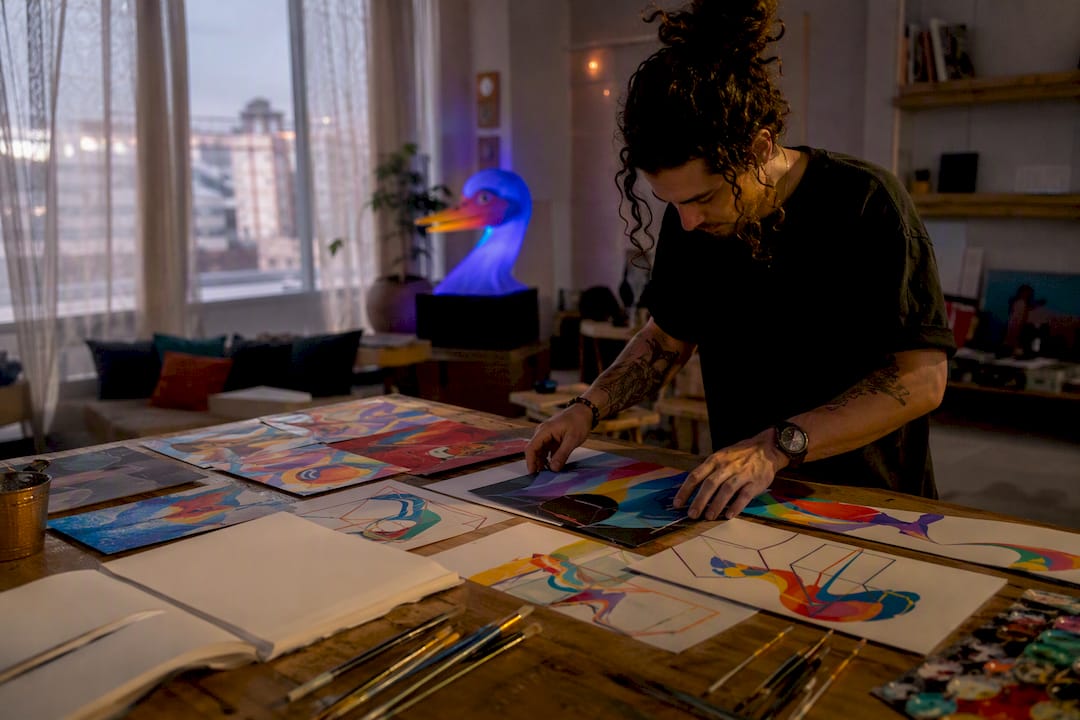 Artist arranging thematic art motifs on table