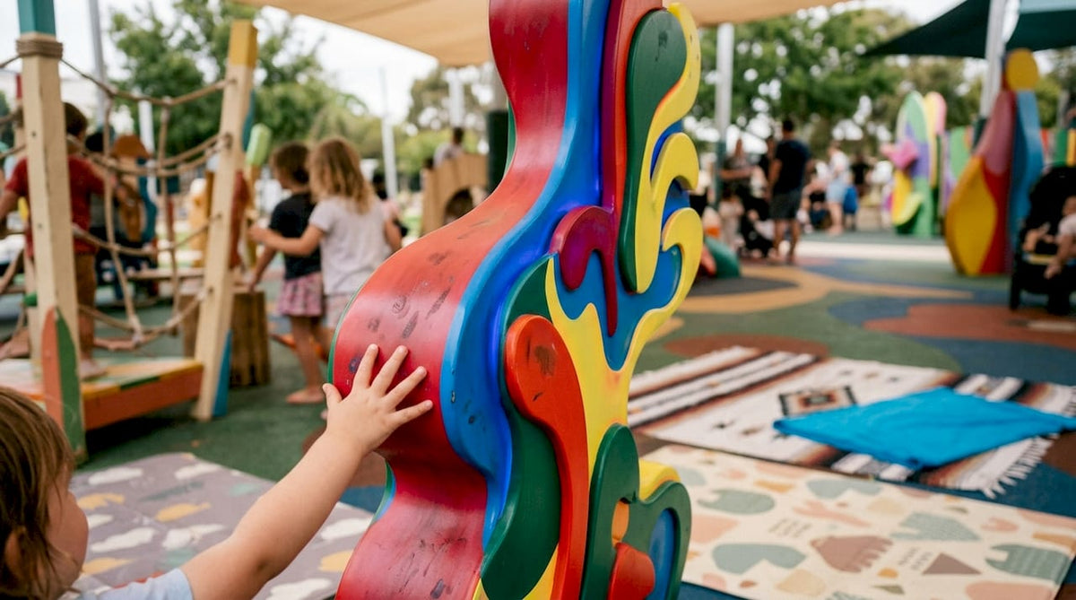 Child touching glowing UV-reactive pop art sculpture