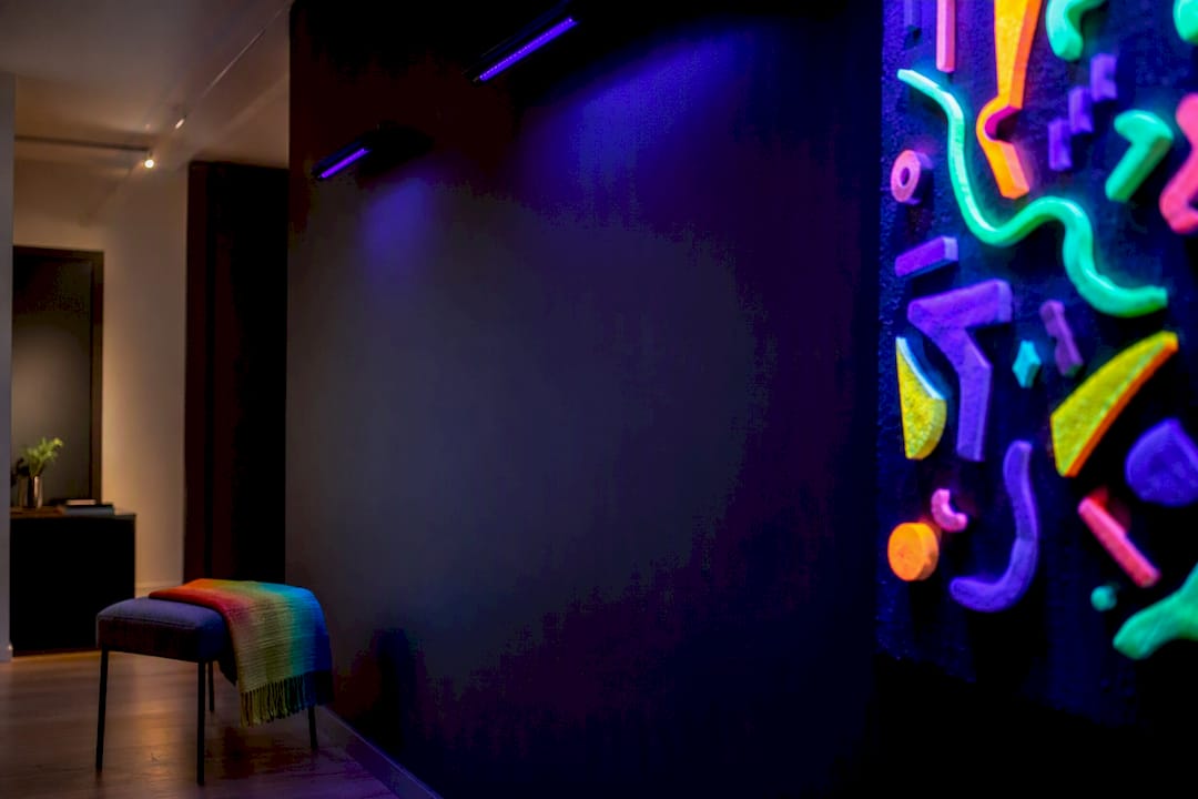 Home gallery room glowing under blacklight
