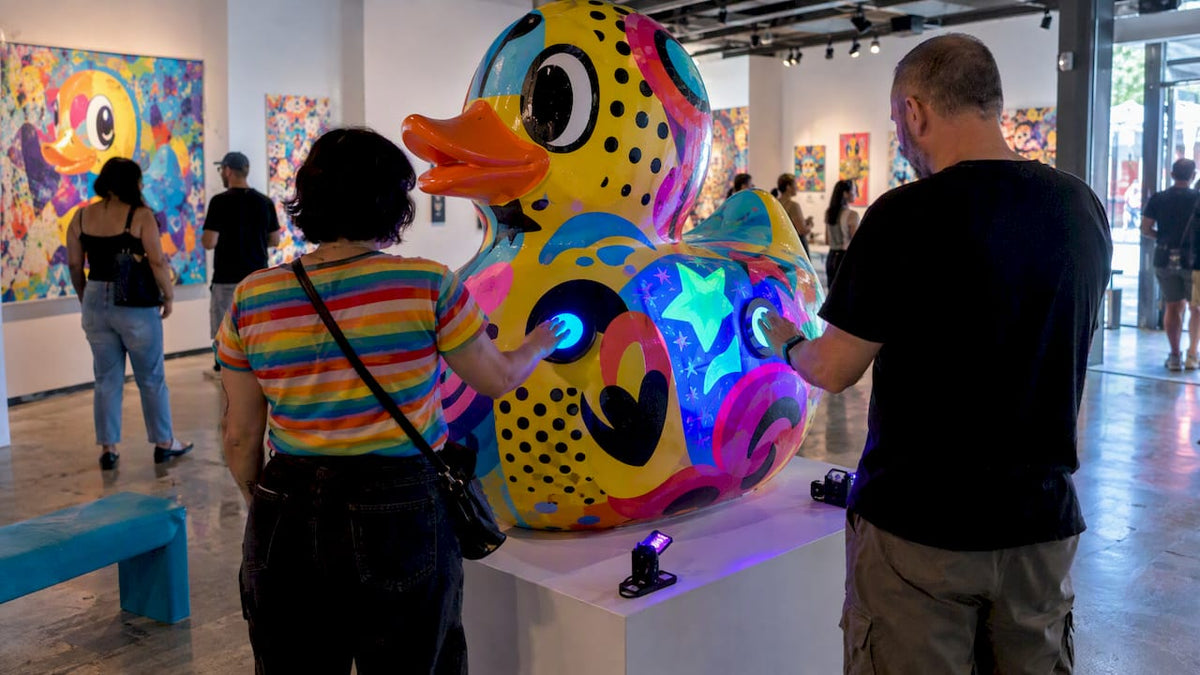 Visitors activating a UV-reactive pop art sculpture