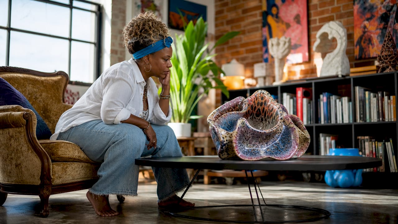 Woman examining bold sculpture in modern living room