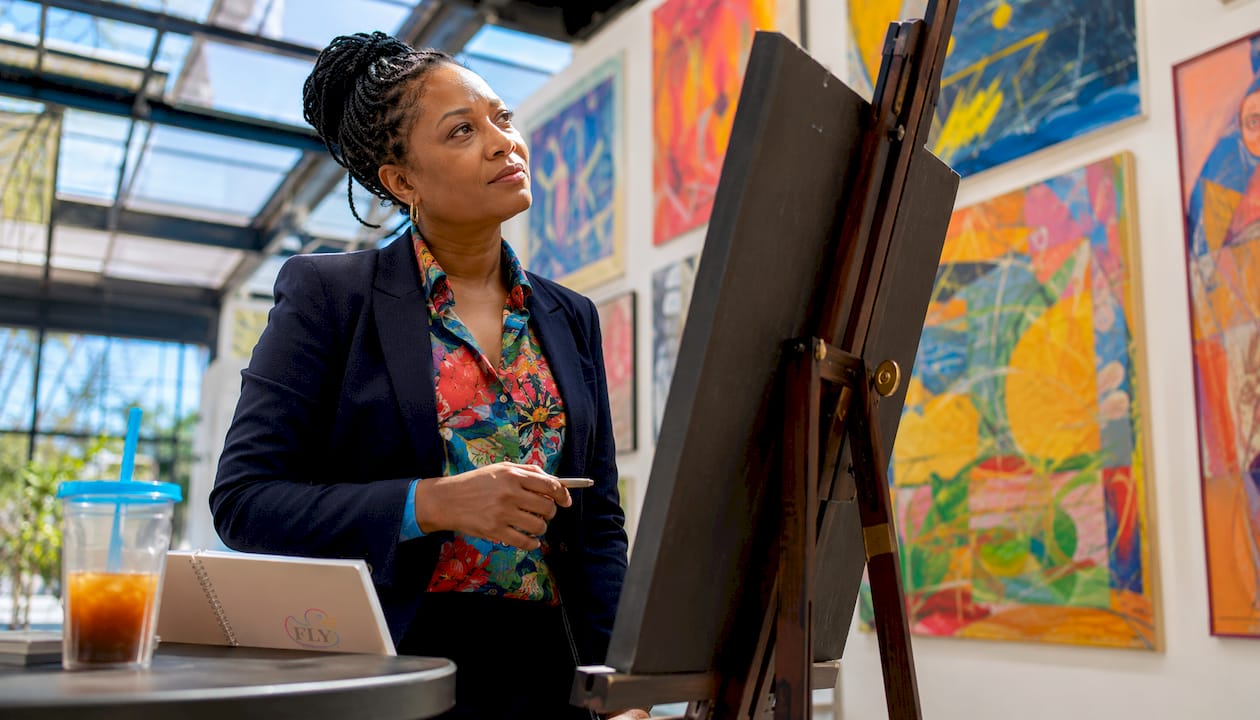 Art curator reviewing award certificates