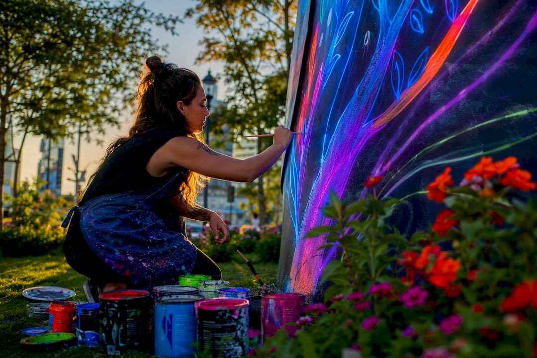 Artist painting outdoor public art sculpture