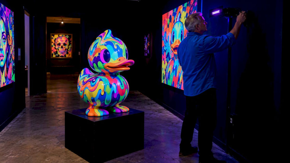 Collector testing UV light on colorful sculpture